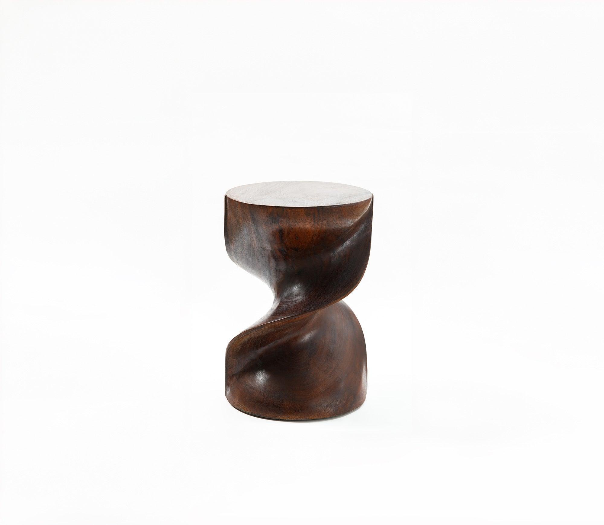 A closeup of tango stool, that shows its curves and beauty of teakwood.