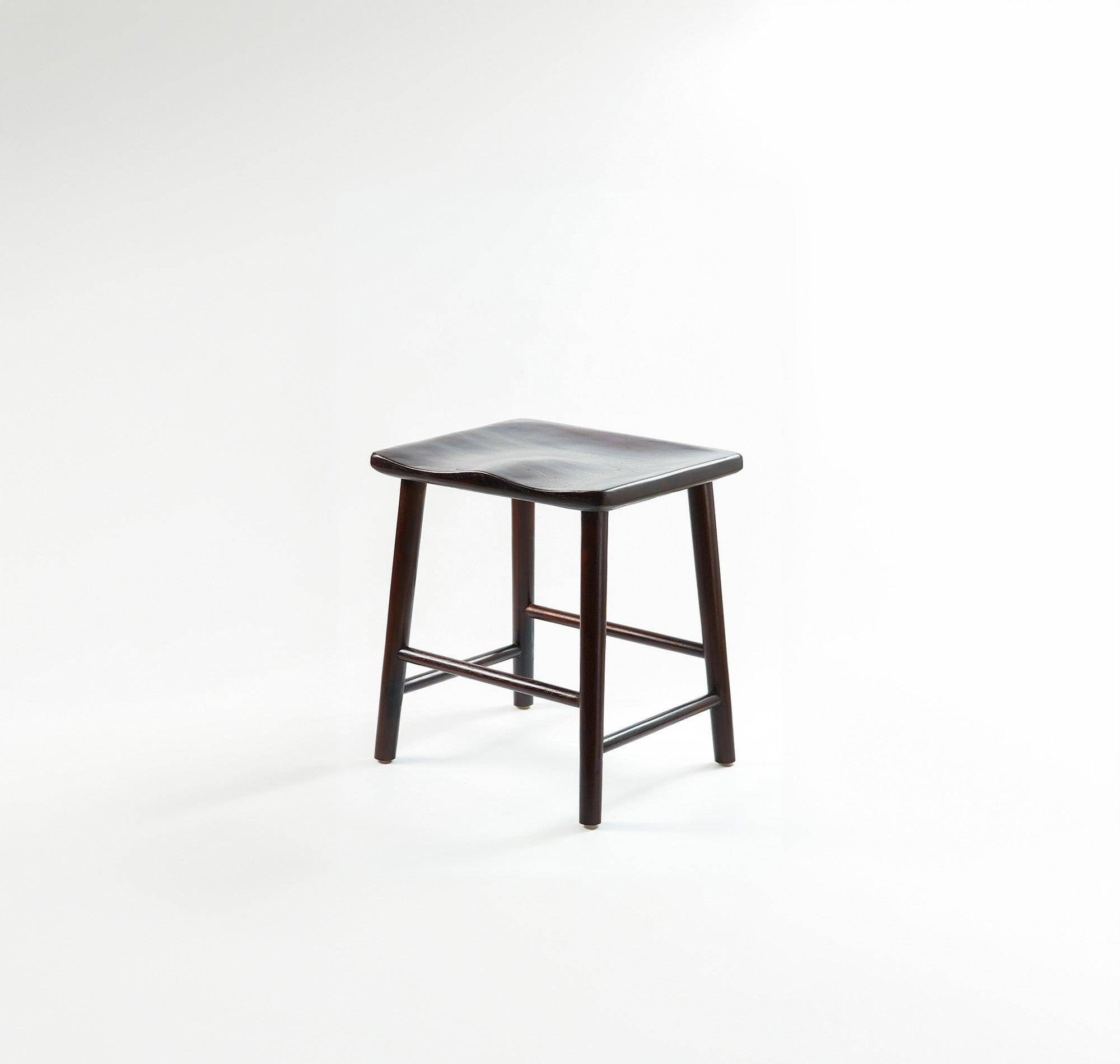 A vintage-style stool with a unique, retro design, perfect for adding a touch of personality to any room.